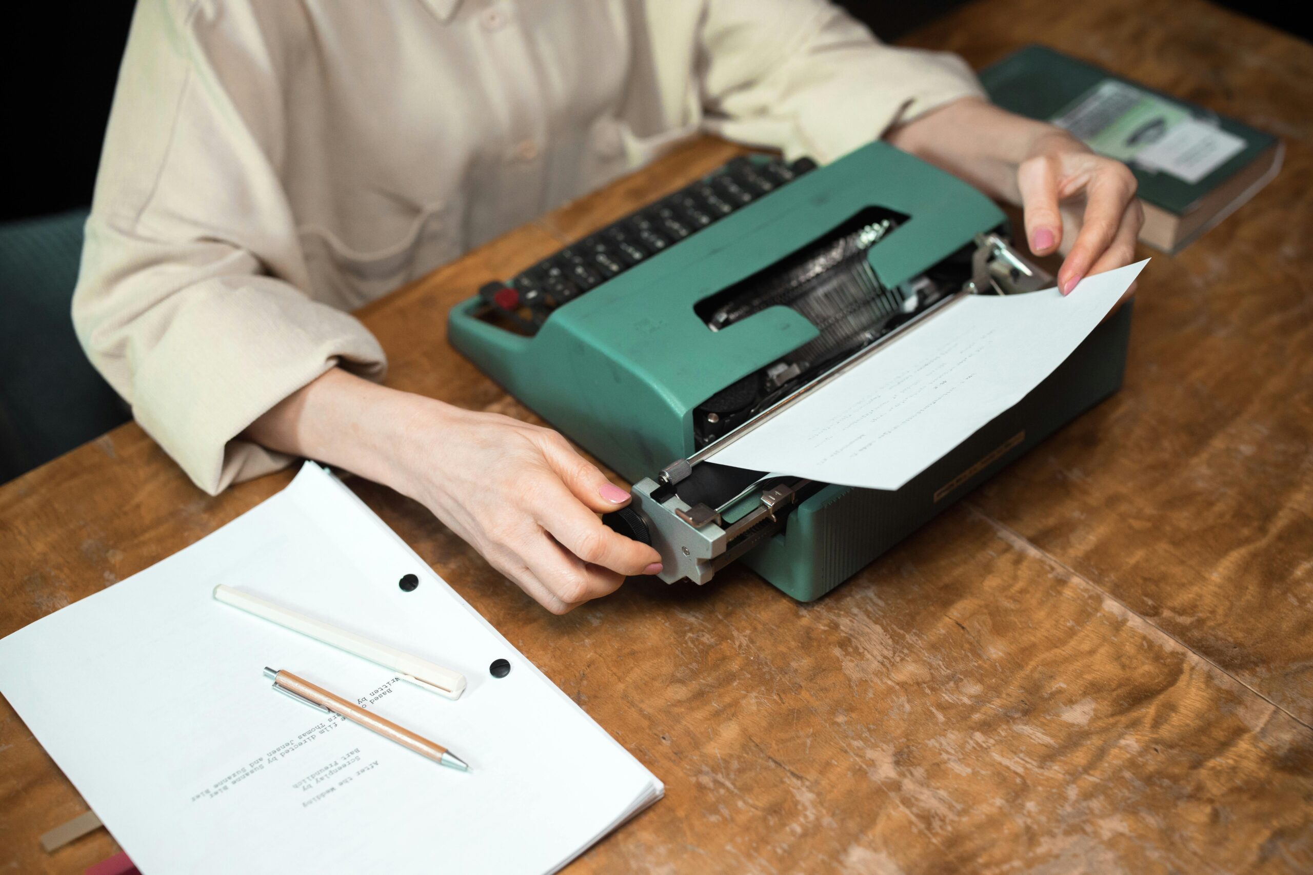 Writer reviewing documents on a desk, representing professional grant writing services, nonprofit support, and monthly retainer credit packages.